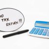 Do your tax return concept with text in speech bubble and calculator on white background