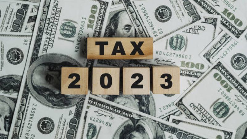 2023 tax concept, paying taxes, 2023, paying tax rates, collecting taxes, tax burden icon on wooden block. Income Statement. paying the tax rate. Taxation, taxes burden. Business concept.